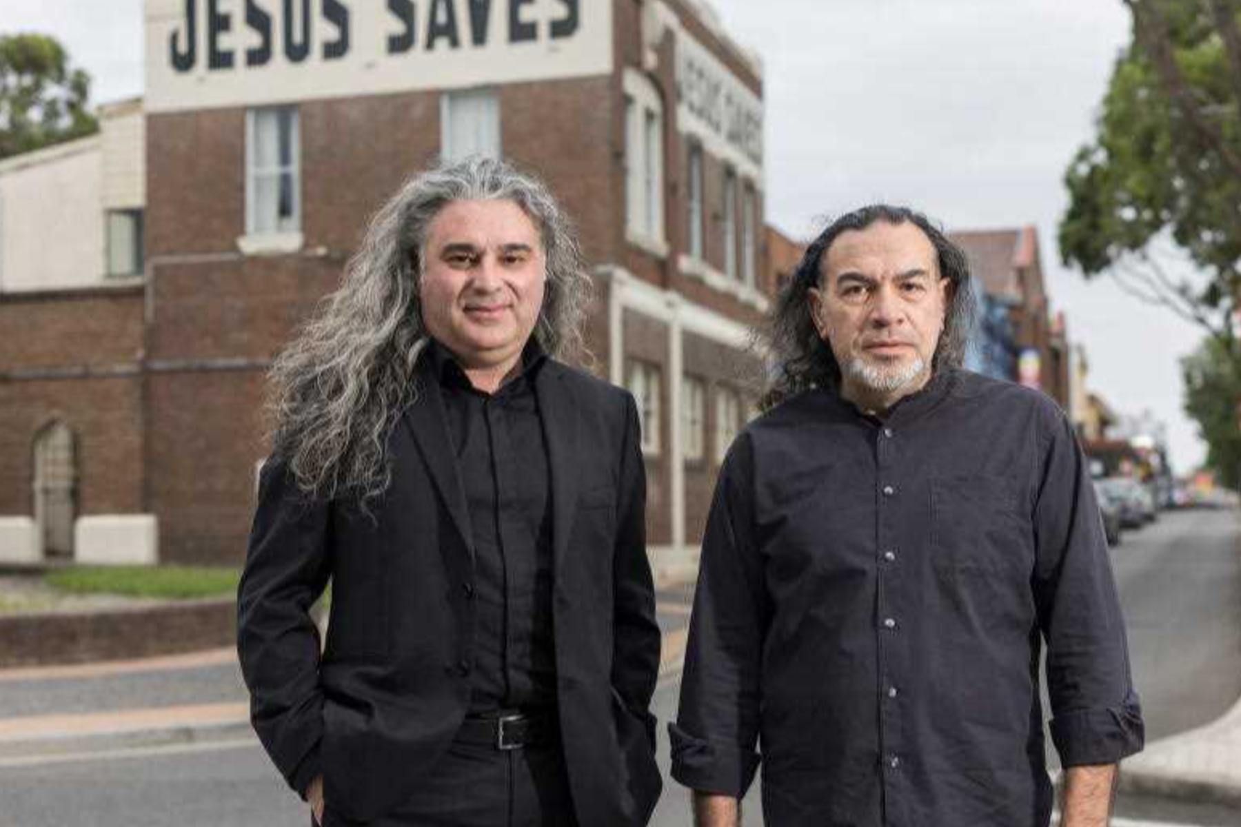 Khaled Sabsabi in front of a Jesus Saves sign and Asia Pacific Arts Awards cancelled